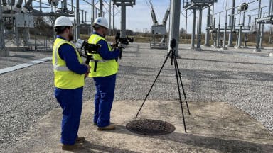 Construction workers using a Matterport camera to scan a job site